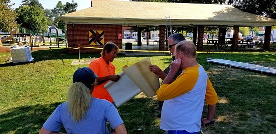 Amish Metal Roofers from Bloomington have been working to replace the roofs on the buildings on the Hope Town Square. Photos by Michael Dean.