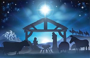 Traditional Christian Christmas Nativity Scene of baby Jesus in the manger with Mary and Joseph in silhouette surrounded by the animals and wise men in the distance with the city of Bethlehem