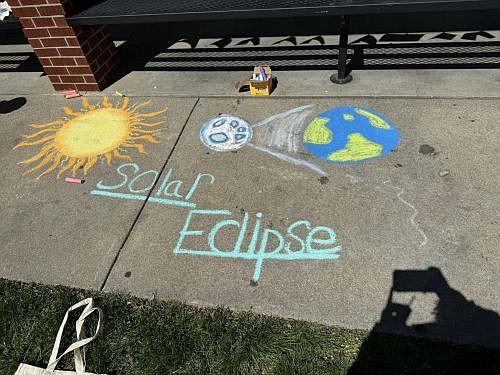 Sidewalk art by local students at the Total Eclipse of the Hope event on the Hope Town Square April 8, 2024. Photo credit: Main Street of Hope.