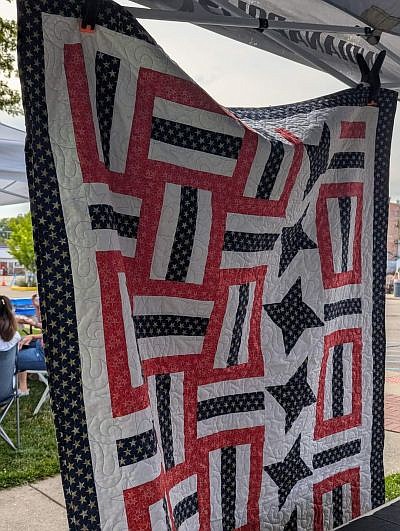 One of several quilts on display at the First Baptist Church booth during the return of Hope's Old-Fashioned Independence Day celebration 2024 on Friday evening, June 28, 2024, hosted by the Yellow Trail Museum on the Hope Town Square in downtown Hope, Ind. Photo credit: Susan Thayer-Fye.