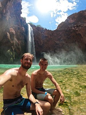 Sam Meek (left) and Jacob Johnson (right) in front of Mooney Falls, Grand Canyon, the day before the flood. August 2024. Photo credit: Sam Meek, submitted.