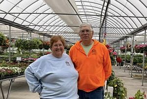 Betsy and Howard Downey in the greenhouse at Duck Creek Gardens in Hope, Ind. Photo credit: Family photo, submitted.