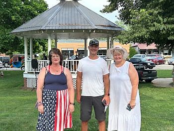 Hope Heritage days board member Chad Miller (center) poses with this year's Grand Marshal as Jessica Deckard (left) and Susan Thayer Fye (right) who accepted the nomination on behalf of the Yellow Trail Museum and Visitor's Center during a ceremony on the Hope Town Square on Thursday afternoon. Aug. 7, 2025. Photo credit: Hope Heritage Days.