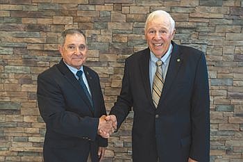 BCREMC Board President Curt Burbrink (right) congratulates Dr. Harker (left) on his 13 years of service to the BCREMC board. Photo credit: BCREMC, submitted.